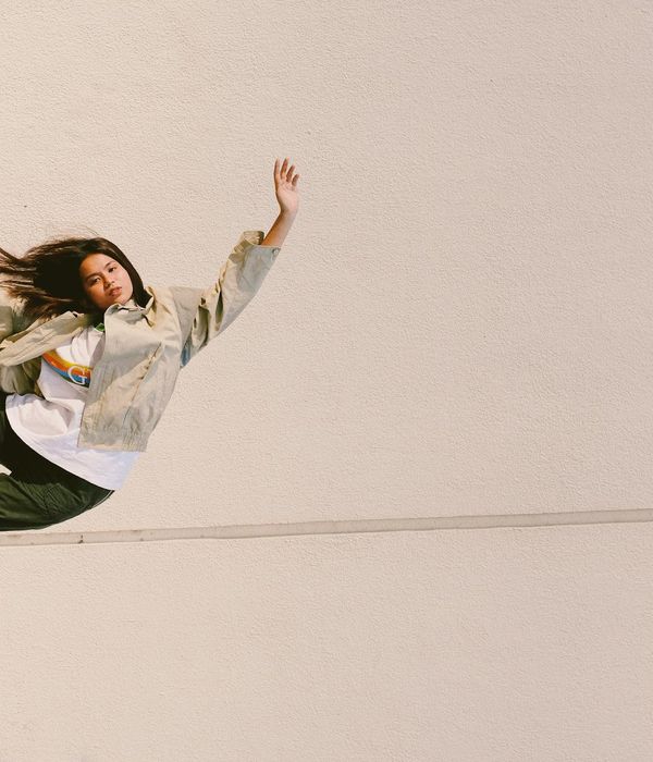 Person in a balancing yoga pose against a clean background.